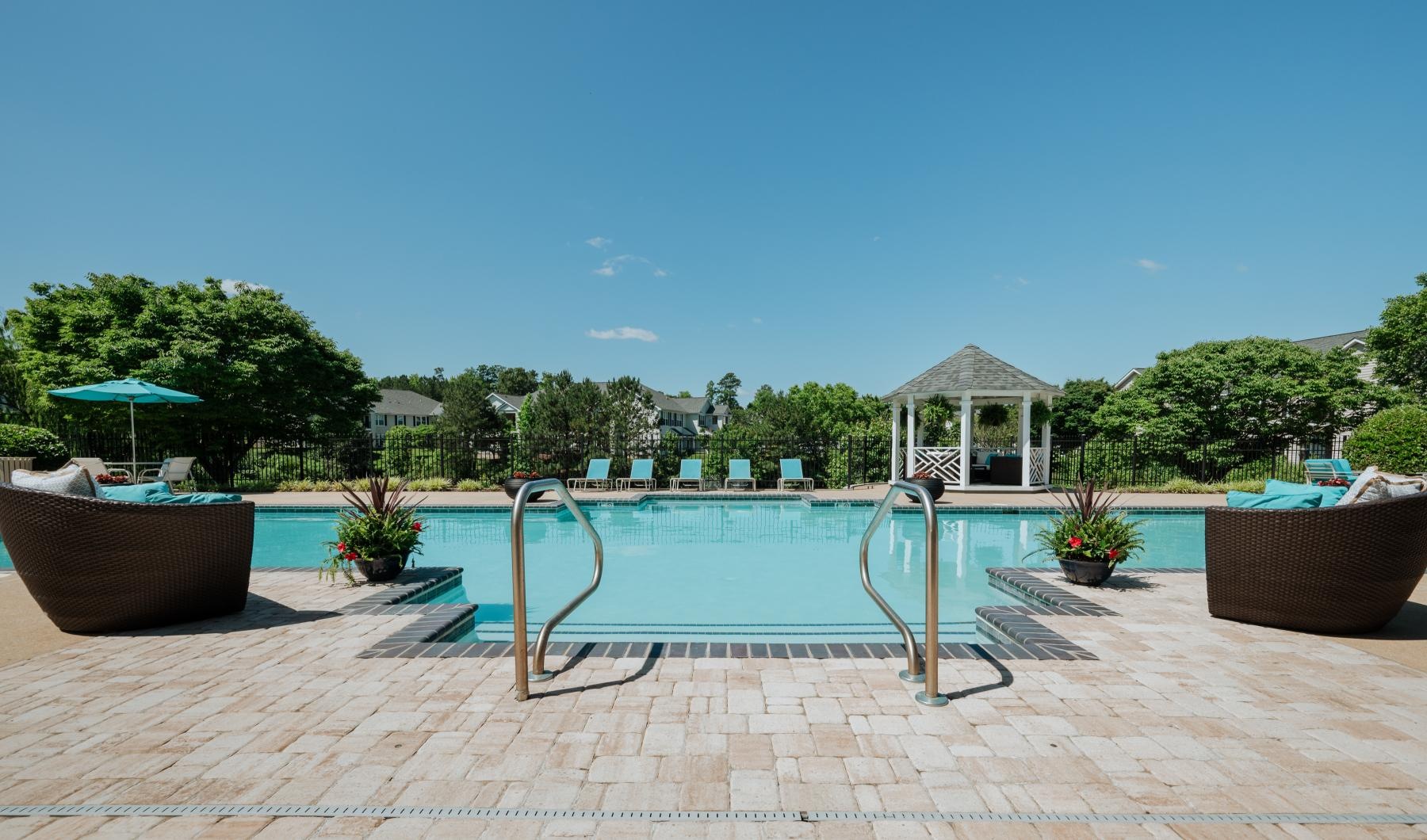 Find your perfect fit at Monticello at Powhatan a pool with a deck and chairs by it and trees in the back